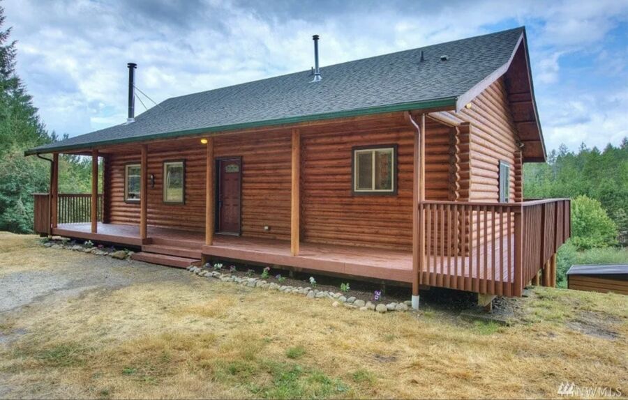 Port Orchard log cabin home with wraparound deck